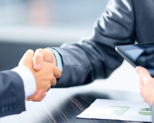 Business people shaking hands in office